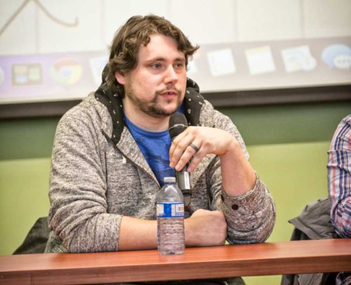 James Black holding microphone at a panel